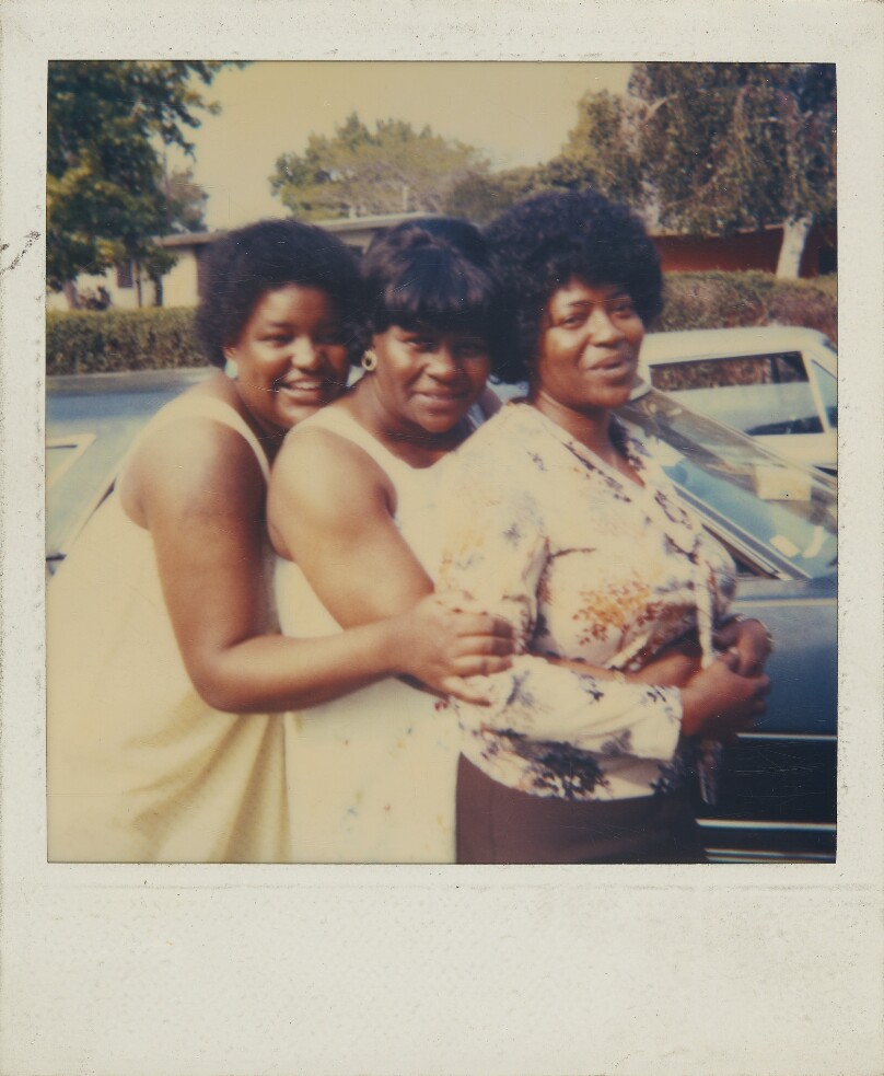 [Three women hugging]