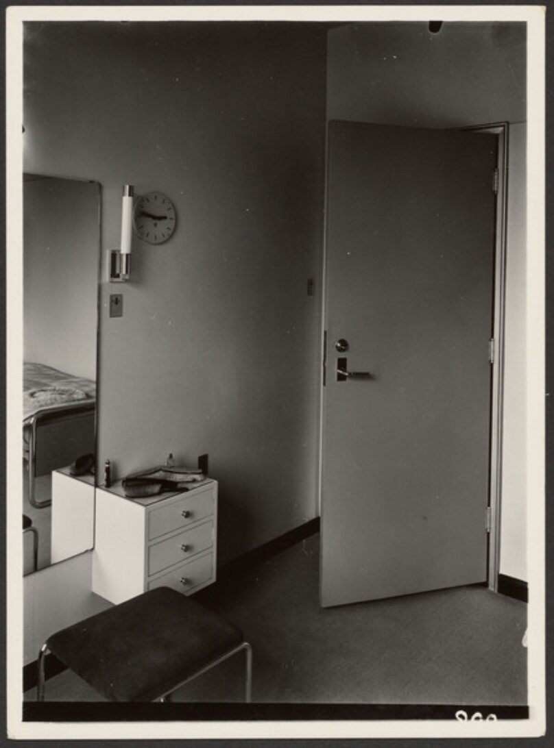 [Small Room with Small Bureau, Mirror, and Bed]