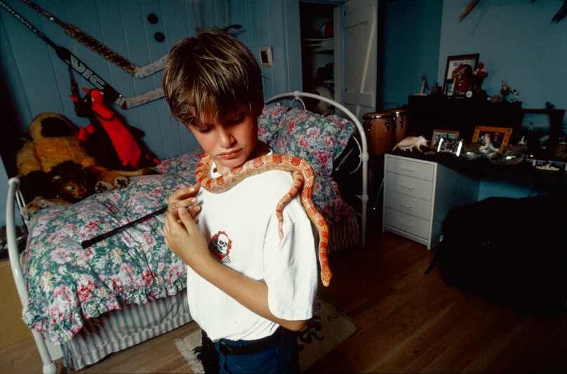 Matthew, 11, in his bedroom with Albino snake, Bel-Air
