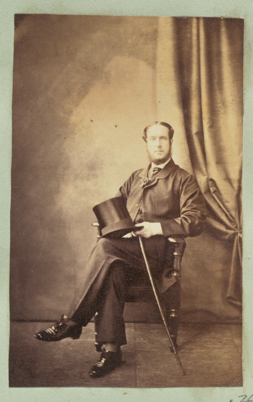 [Portrait of a seated man holding a top hat]