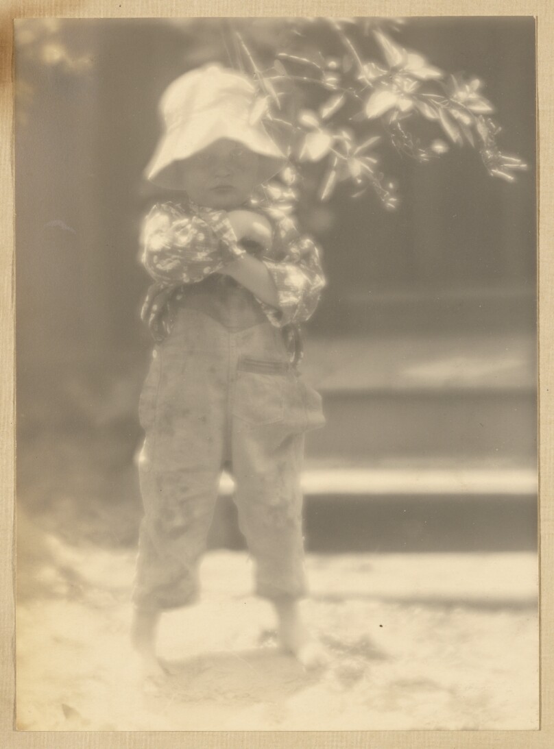 [Brett Weston, in overalls, standing, full-length view]