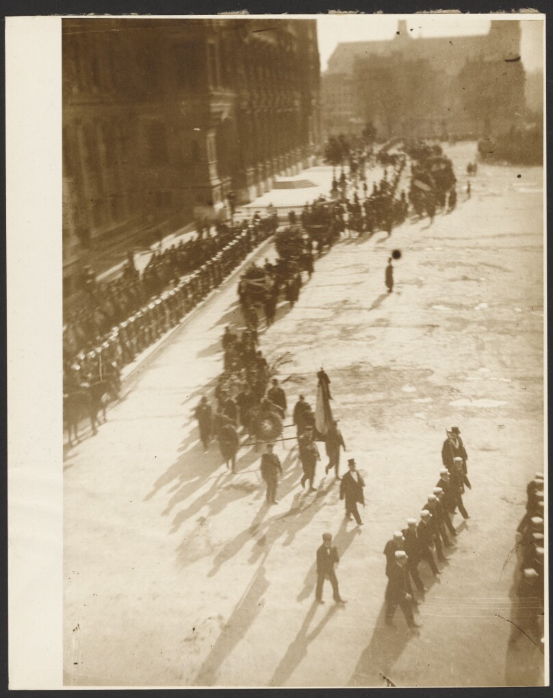 [Procession of Uniformed Men in an Unidentified Town Square]