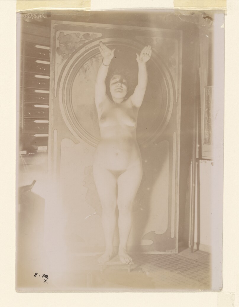 [Female nude posed with raised arms]