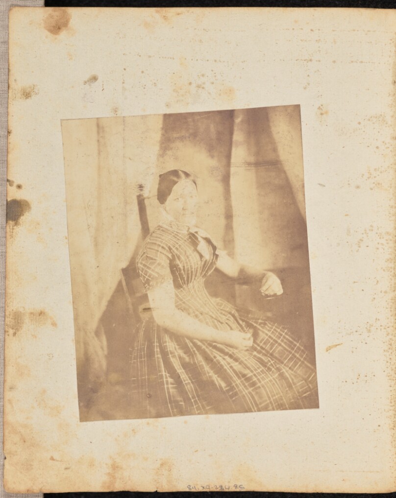 [Portrait of a woman in a plaid dress]