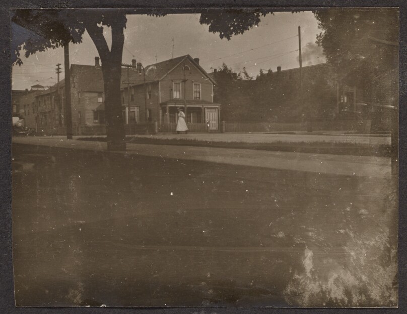 [Woman walking down a sidewalk]