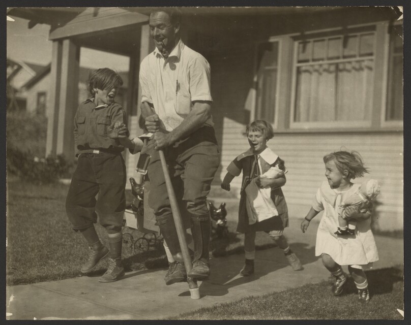 [Man on pogo stick with children]