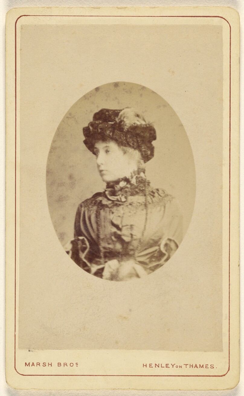 [Unidentified young woman wearing a hat with a plume, printed in quasi-oval style]