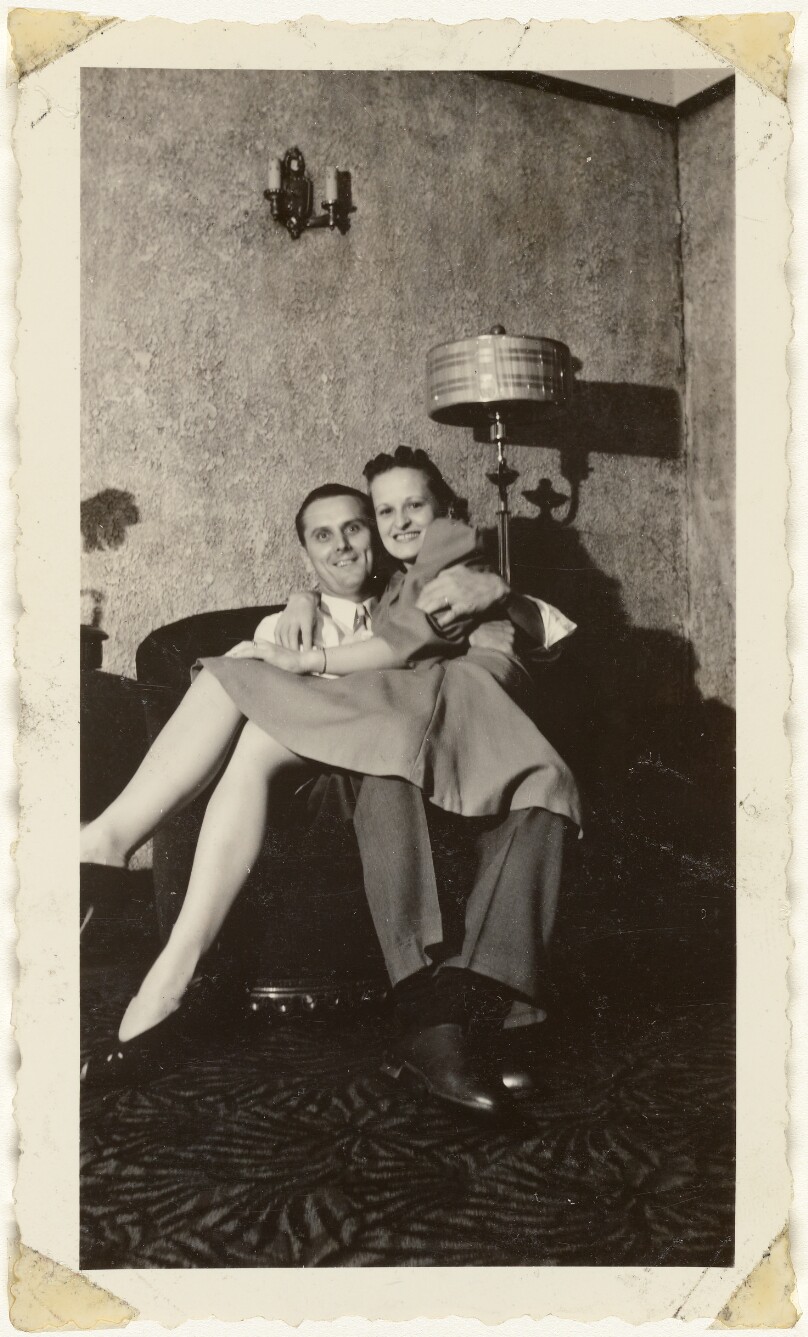 [Man and woman sitting in chair]