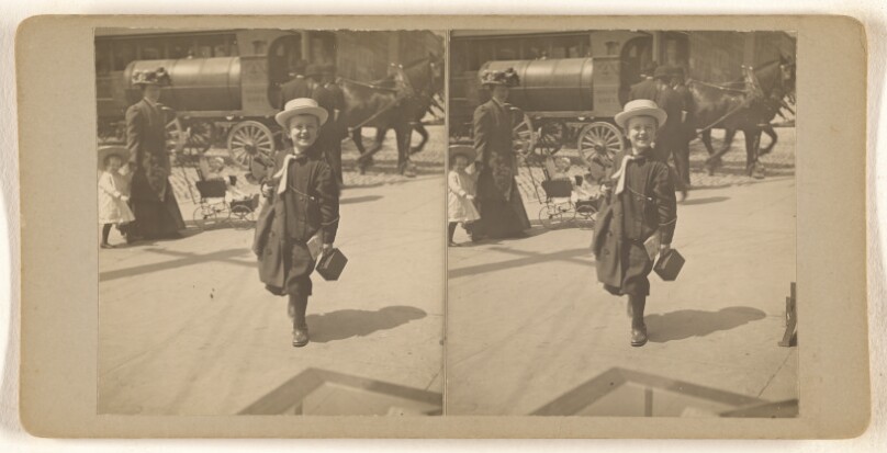 [Little boy in straw hat carrying lunchbox, walking on street, Albany, N.Y.]