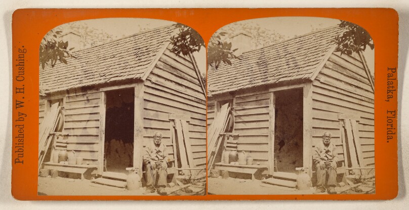 [Elder black man seated in from of small cabin, Florida]