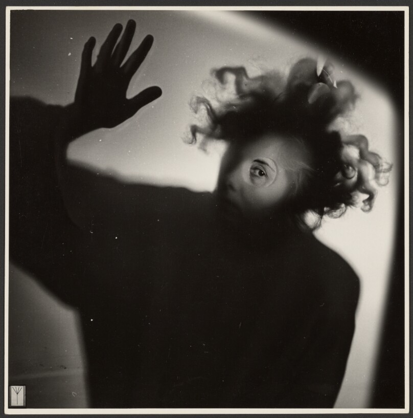 [Face and hand pressed against glass]