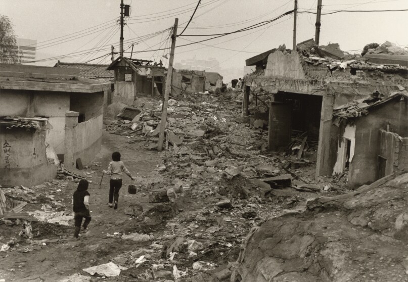 [Two Girls Walking Up a Path in the Midst of Ruins from a Recent Demolition of Housing Units]