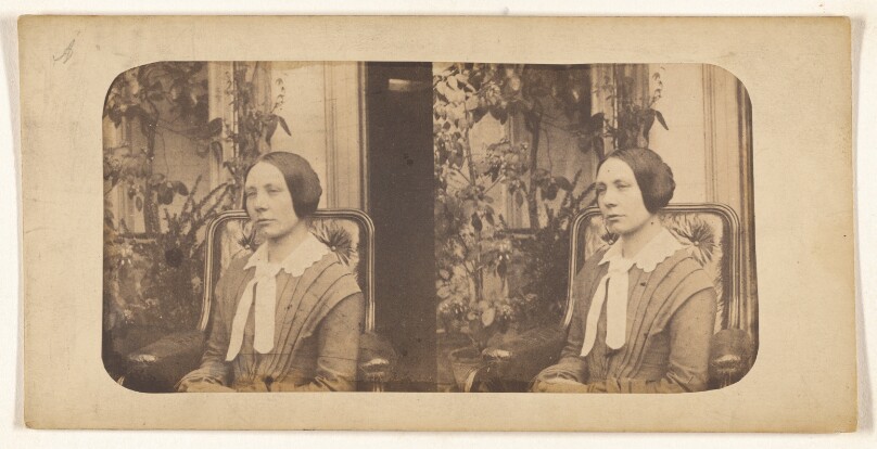 [Woman with hair pulled back, seated]