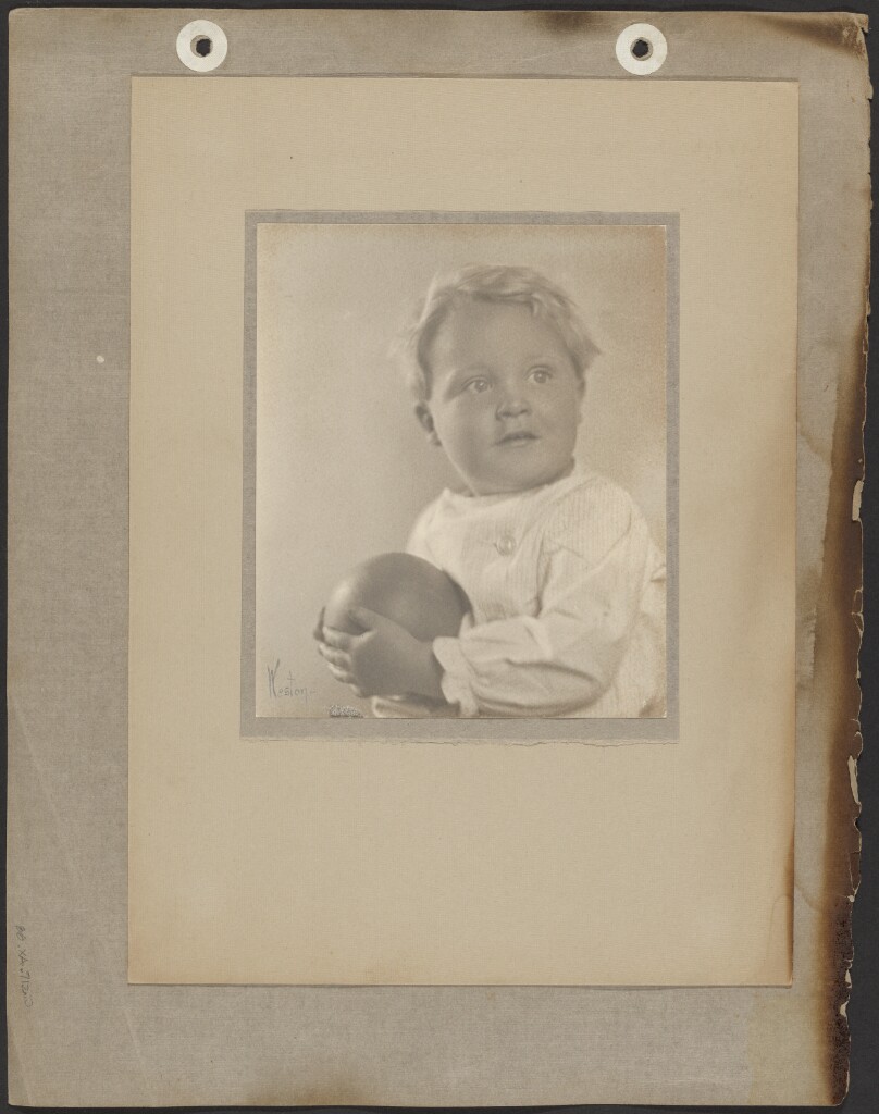 [Brett Weston dressed in white tunic holding ball]