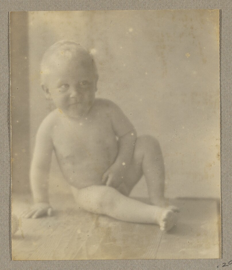 [Neil Weston nude, seated on wood shelf]