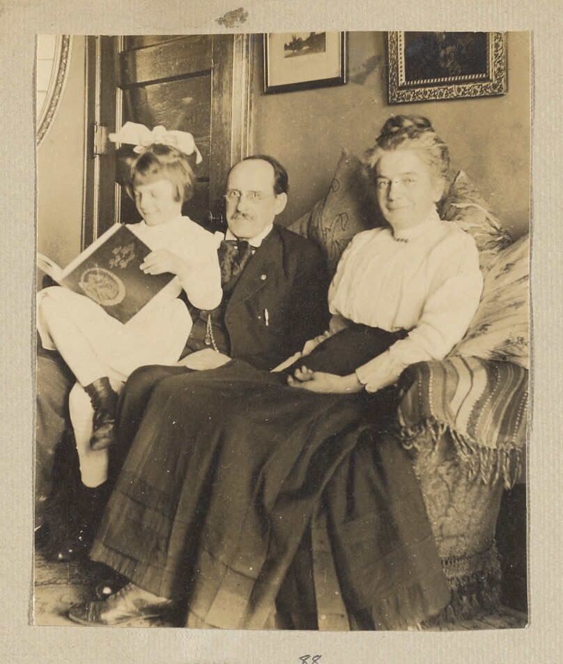 [Man, woman and child, seated]
