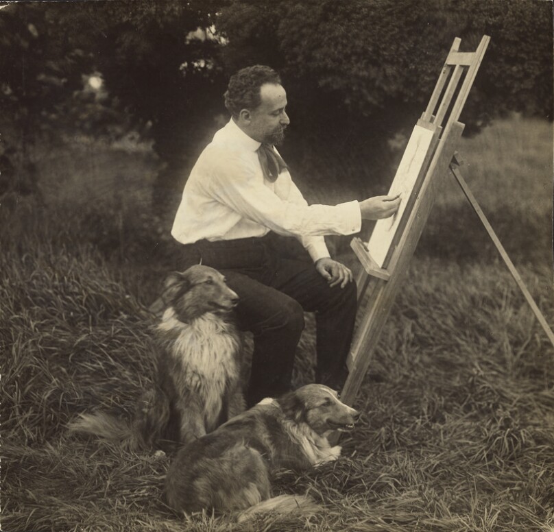 [Artist at easel with two dogs]