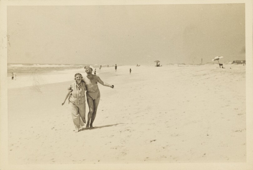 [Man and woman walking on the beach]
