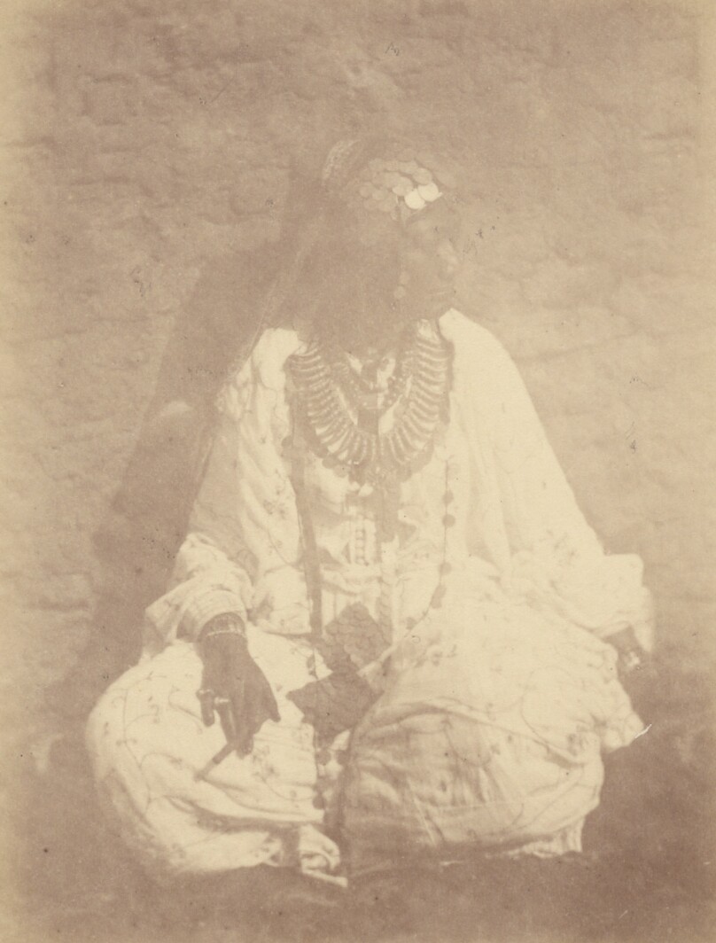 [Portrait of a North African Woman Sitting Against a Wall]