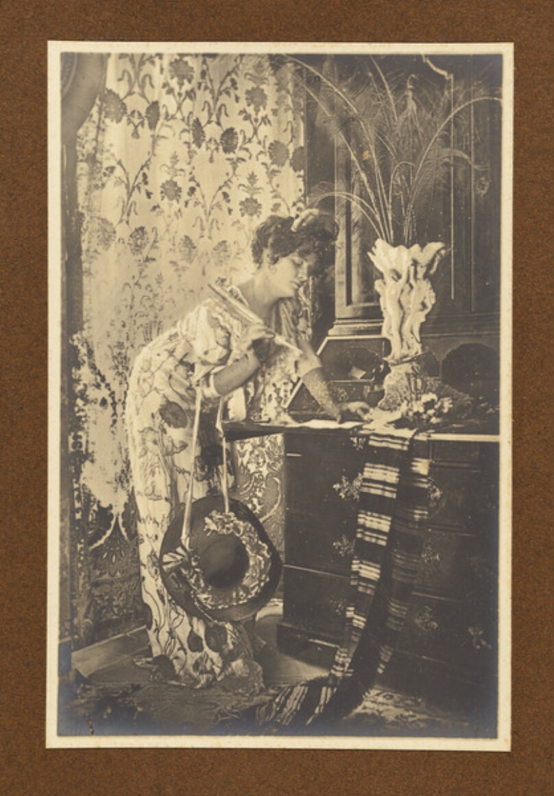 [Woman writing letter]