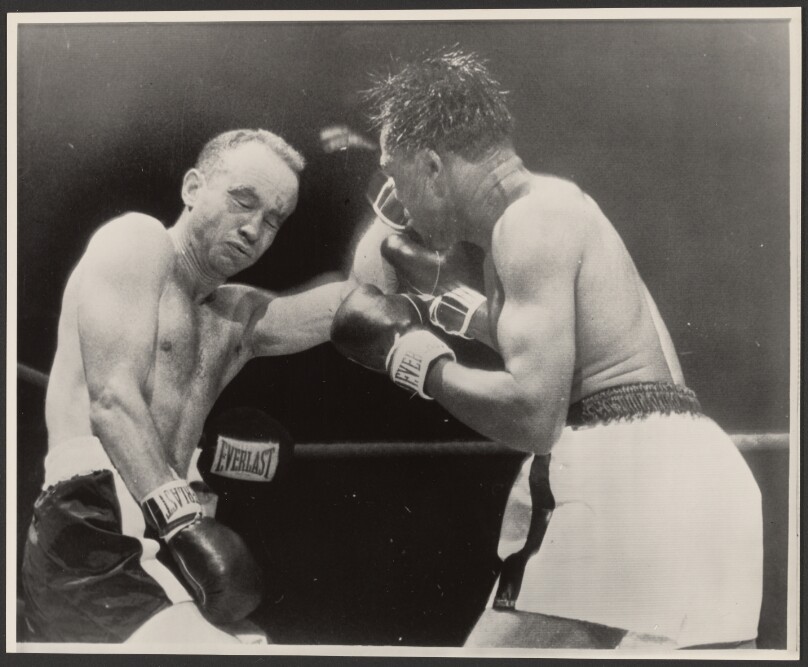 [Two boxers fighting]