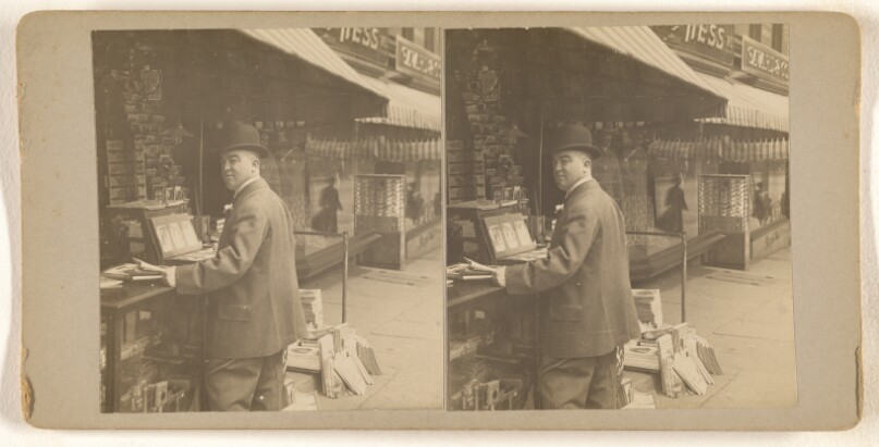 [Man standing at counter of Coulson & Wendt's News and Novelty Stand, Albany N.Y.]