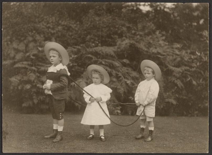 [Three children playing outdoors]