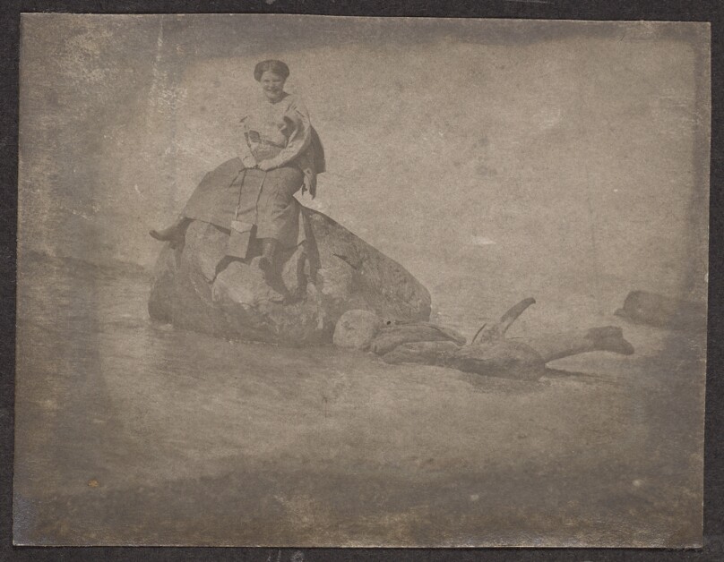 [Woman sitting on a rock]