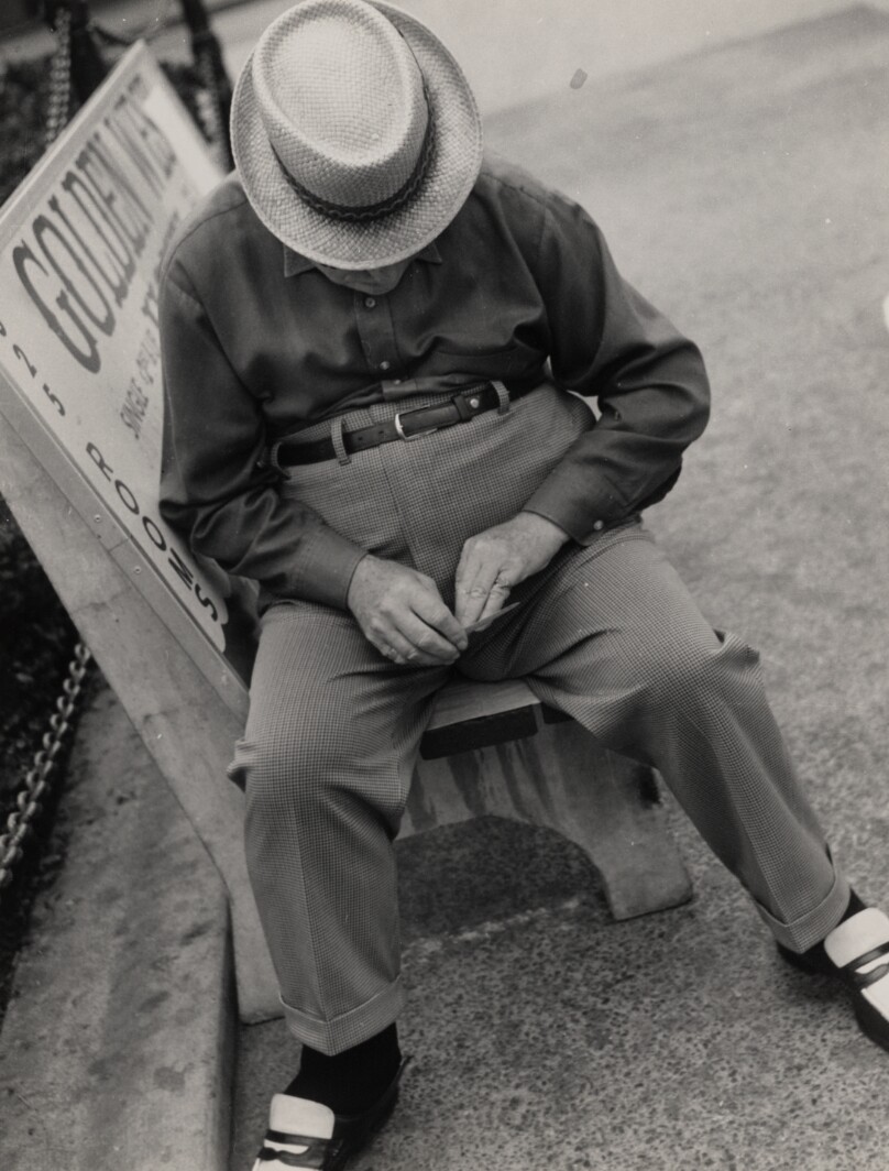 [Seated man with hat]