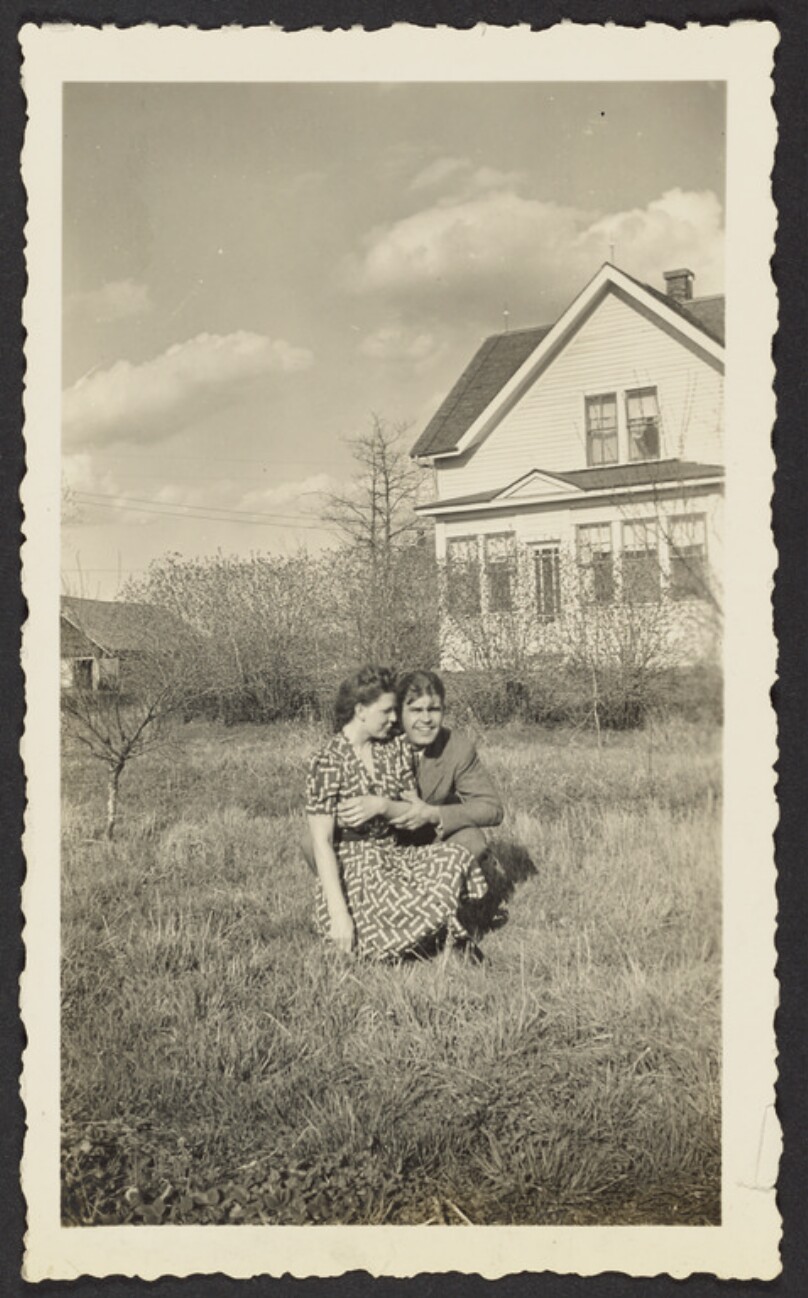 [Kneeling couple in field]