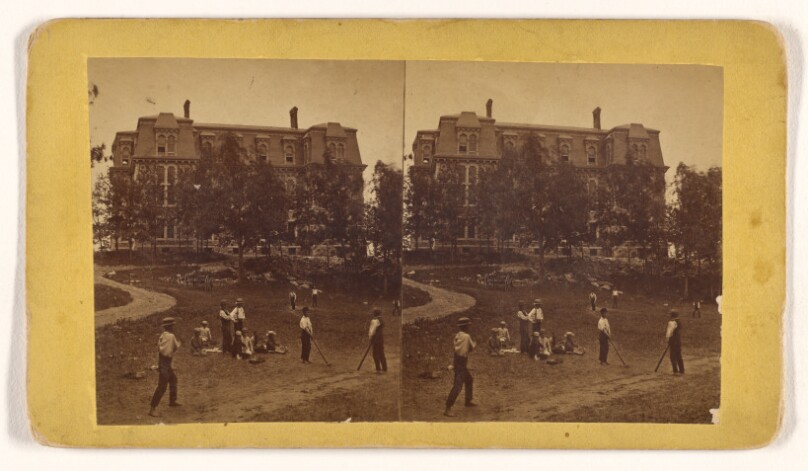 [Boys playing baseball, large building in background, in the vicinity of Worcester, Massachusetts]