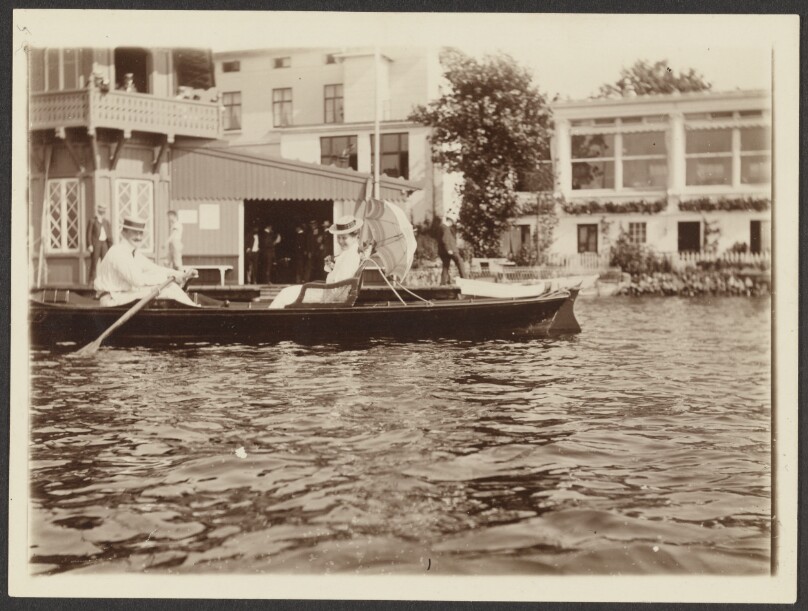 [Man rowing a woman around in a boat]