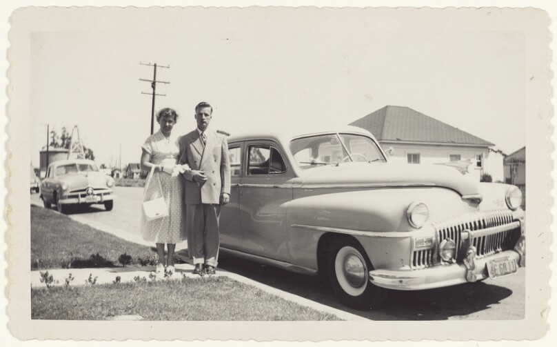 [Man and woman next to car]