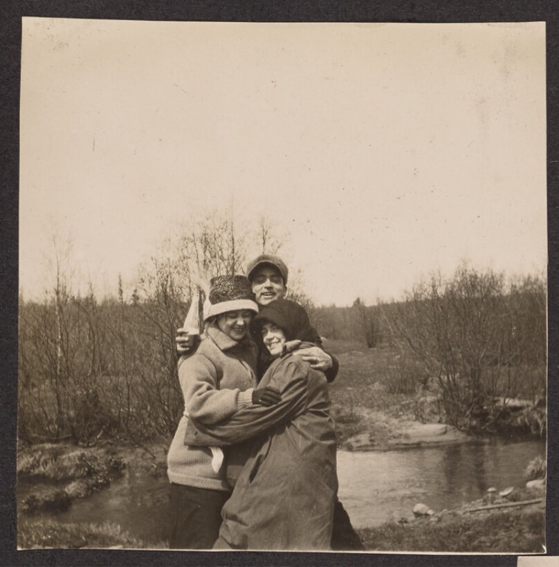[Group portrait in front of a pond]