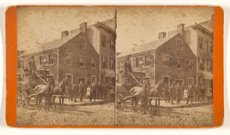 [Group of people on street corner, horse-drawn wagon to left]