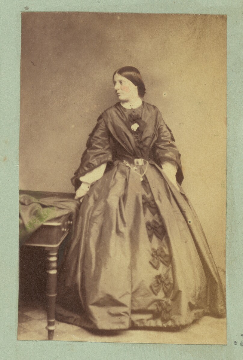 [Portrait of woman wearing dress with bows]