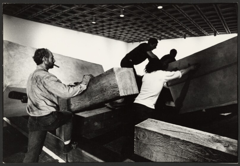 Robert Morris installing wooden beams, Whitney Museum of American Art