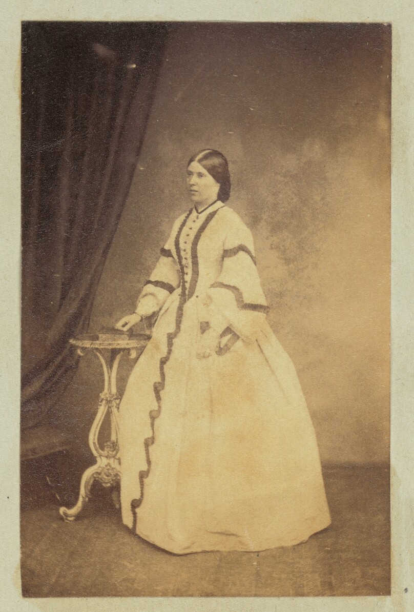 [Portrait of woman in dress with striped sleeves]