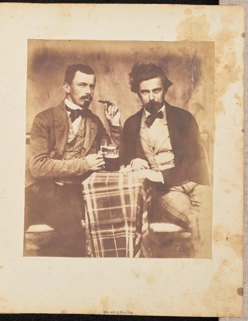 [Portrait of two men at a table]