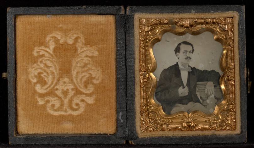 [Portrait of a Man Seated at a Table with His Elbow Propped on Books]