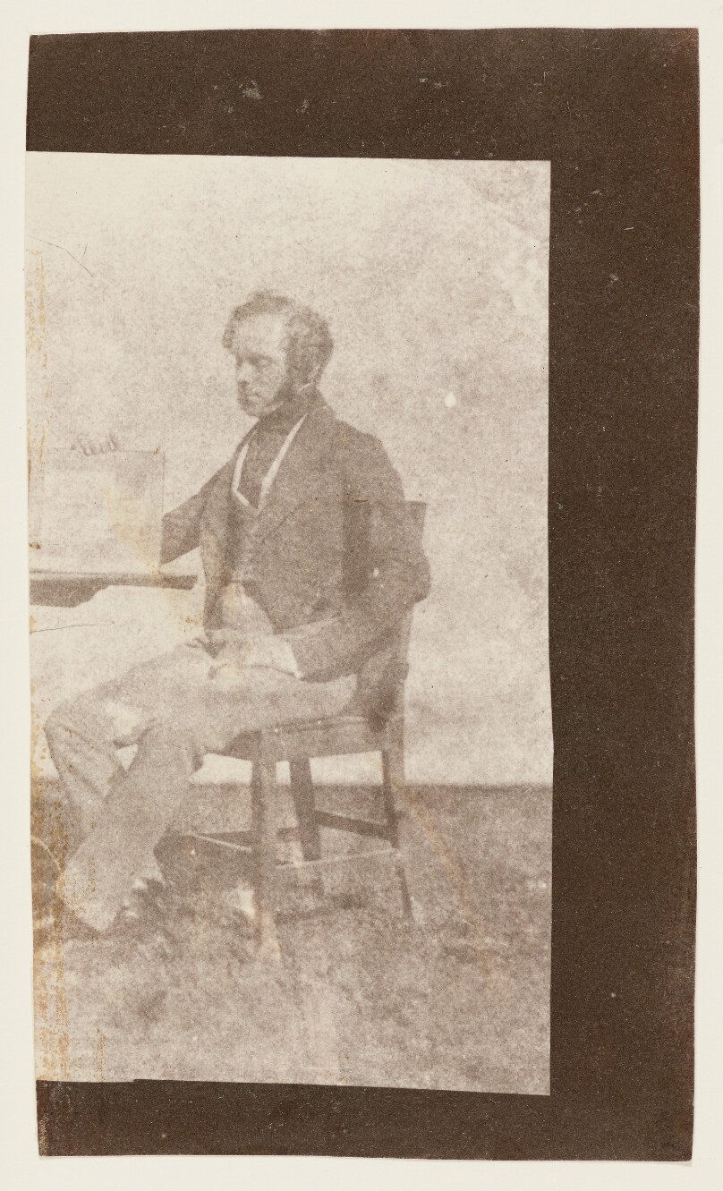 [Nicolaas Henneman, Holding up a Print in an Album]