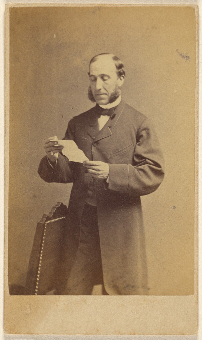 [Man with muttonchops reading a letter, standing]