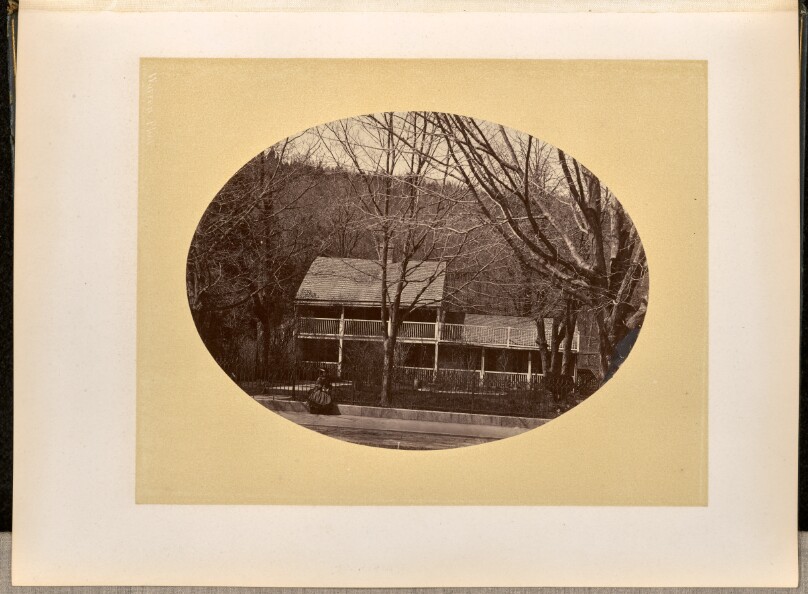 [Woman stands in front of a house, West Point]