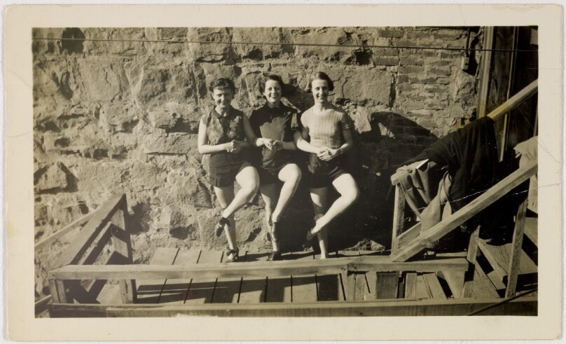 [Three women with crossed legs]