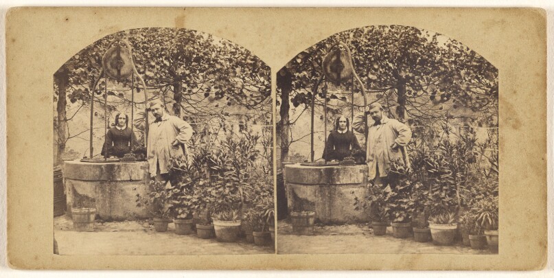 [Young French couple standing in their garden near a well]