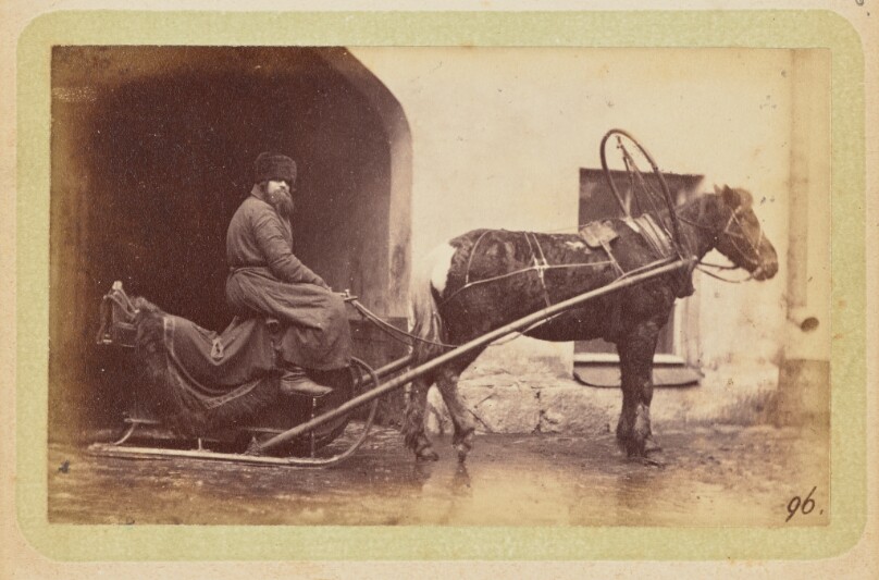 [Man driving horse-drawn sleigh]