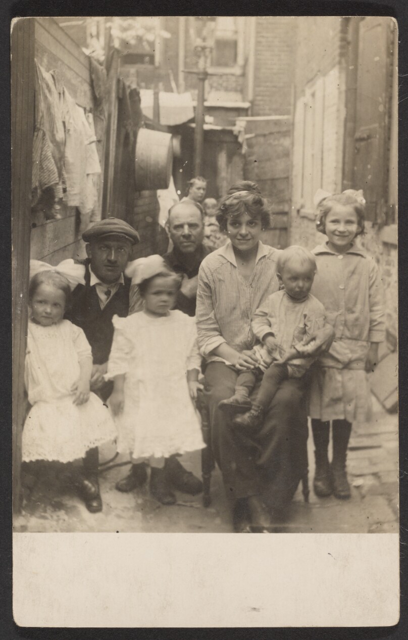 [Family portrait in tenement alley]