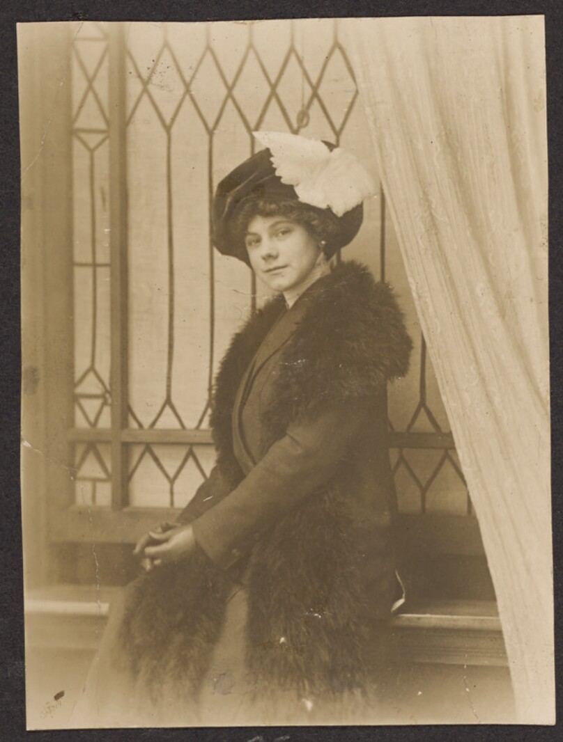 [Woman sitting on a window sill]