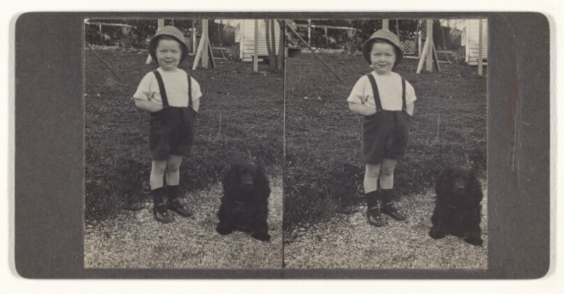 [Unidentified little boy standing with dog on the lawn] (recto); A Kaffir Police Boy and Convict. Johannesburg, Transvaal (verso)