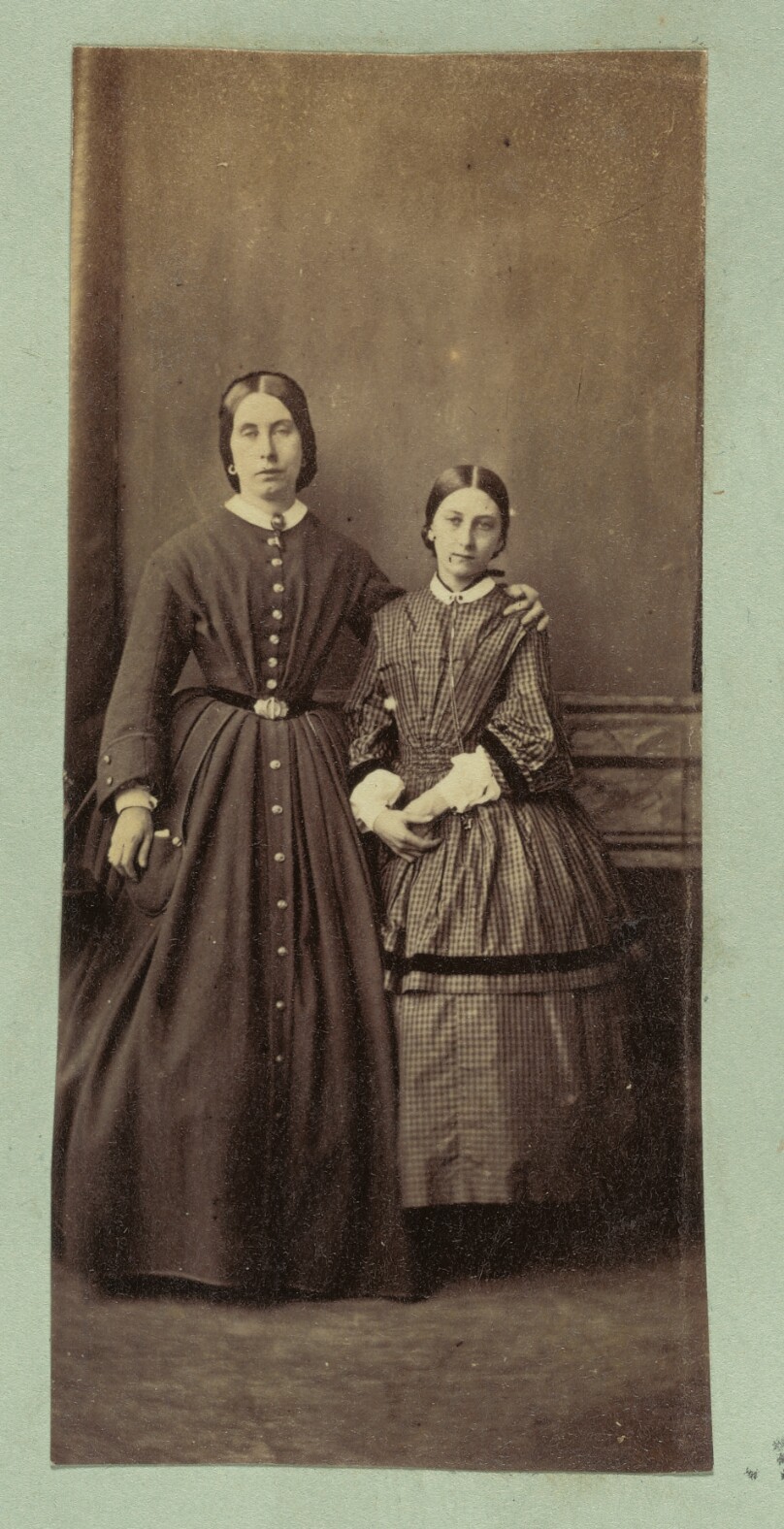 [Portrait of woman with arm around girl]